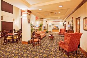 a lobby of a hotel with chairs and tables at Holiday Inn Express Hotel & Suites Lucedale by IHG in Lucedale