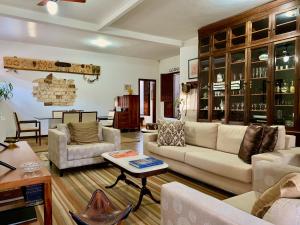 a living room with a couch and a table at Pousada Nossa Terra in Rio Novo