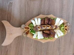 a plate of food with meat and vegetables on a table at Casa ERIC in Mila Douăzeci şi Trei