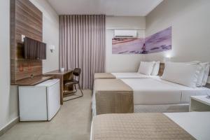 Postel nebo postele na pokoji v ubytování Tambaqui Praia Hotel