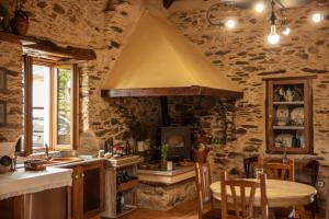 a kitchen with a sink and a stove top oven at Lugar del Rio in Couzadoiro