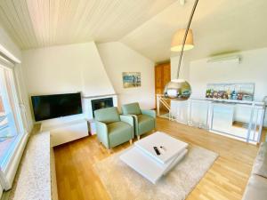 a living room with a couch and a tv at Tower 44 in Luino