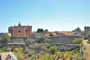 an old town with a castle in the distance at Masseria Spina Resort in Monopoli
