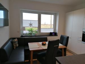 a living room with a couch and a table at Gästezimmer Bergerhof - Ankommen und Wohlfühlen in Neuss