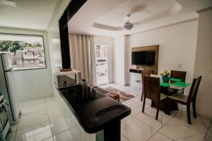 a living room with a piano and a dining room at Excelente custo beneficio para até 5 pessoas in Domingos Martins +24 photos