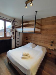 a bedroom with a bunk bed with a ladder at Hôtel le Christiania in Arêches-Beaufort