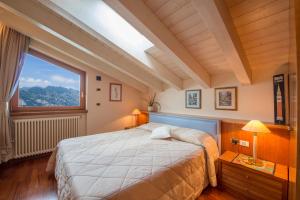 a bedroom with a large bed and a large window at Villa Malcesine in Malcesine +39 photos