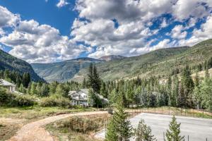 a house in the mountains with a road at Beautiful East Vail 3 Bedroom Condo w/Hot Tub On shuttle Route. in Vail