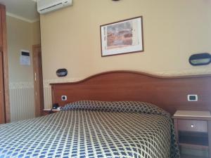Postel nebo postele na pokoji v ubytování Hotel Grifone
