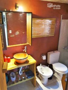 a bathroom with a sink and a toilet at OHANA in Punta Del Diablo