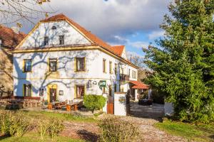 a large white house with a table in front of it at Penzion u lípy in Jestřebí