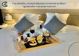 
a tray filled with food on top of a bed at Golden Tulip Bordeaux Euratlantique in Bordeaux
