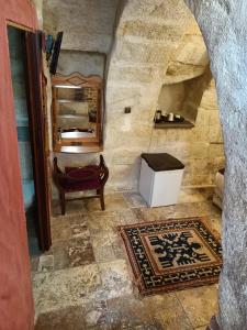 a hallway with a room with a mirror and a table at Naturels Cave House in Ürgüp