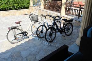 three bikes parked next to each other on a sidewalk at Mirabelle Hotel in Argasi