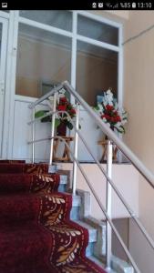 a staircase with flowers on the side of a building at Çiftlik otel 