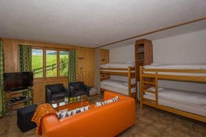 a living room with two bunk beds and a couch at Chalet Falki in Adelboden