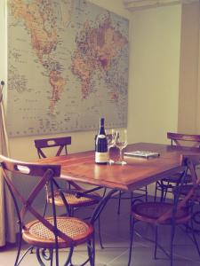 a bottle of wine sitting on a wooden table with wine glasses at La Cuvée-Saint-Georges in Nuits-Saint-Georges