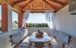 a table with a bowl of fruit on a balcony at Apartment Istria in Peroj