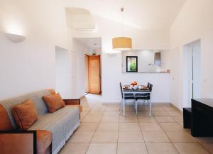 a living room with a couch and a table at Résidence Les Terrasses de Rondinara in Bonifacio