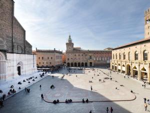 a courtyard in a building with people walking around at UR-NEST Montegrappa in Bologna