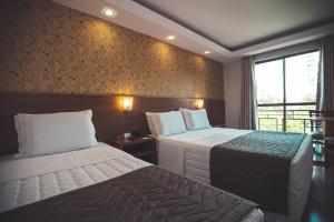 Postel nebo postele na pokoji v ubytování Hotel Rafain Centro