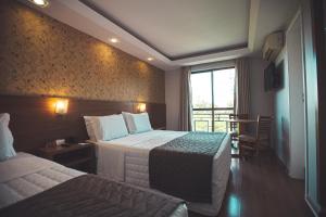 Postel nebo postele na pokoji v ubytování Hotel Rafain Centro