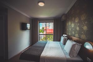 Postel nebo postele na pokoji v ubytování Hotel Rafain Centro