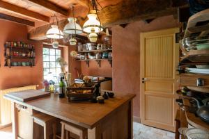 a kitchen with a large wooden island in a room at Cottage les Forières in Saint-Honoré