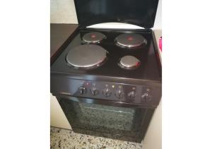 a stove top oven sitting in a kitchen at Kikilia's & Stelio's Apartments in Adamas