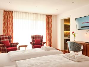 Giường trong phòng chung tại Hotel Hornstein - Weingut, Vinothek & Gastronomie