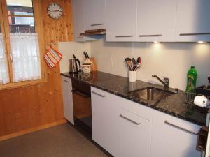 a kitchen with a sink and a counter top at Chalet Azeno OG in Adelboden
