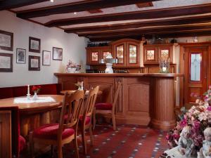 a dining room with a table and a kitchen at Landhotel Halbfas-Alterauge in Drolshagen