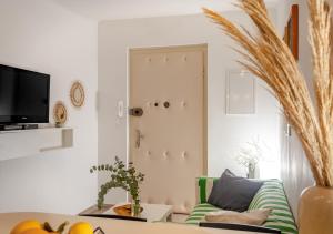 a living room with a green couch and a tv at Apartment Spalatin in Split