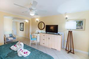 a living room with a tv and a couch at Bay Gardens Beach Resort & Spa in Gros Islet