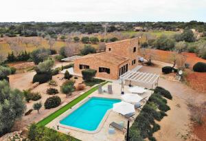 an aerial view of a home with a swimming pool and a house at Finca Can Xesquet Camí de Morell 169 by Mallorca Charme in Ses Salines