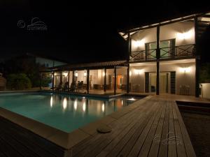 a swimming pool in front of a house at night at Kas Vis in Kralendijk