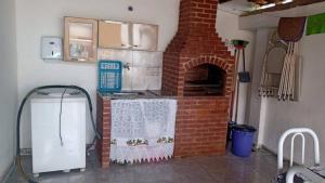 a kitchen with a brick oven in a room at Casa Aconchegante in Araruama