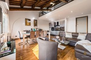 a living room with a couch and a table at Villa Guinigi Dimora di Epoca Exclusive Residence & Pool in Lucca