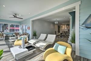 a living room with yellow chairs and a blue wall at Luxurious Waterfront Home with Private Pier and Views! in Georgetown