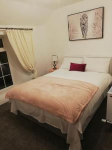 a bedroom with a large bed with a red pillow at Ardhill House B&B The Diamond, in the Heart of Ardara Town , F94 C7X9 in Ardara