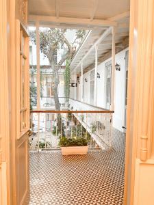 an open door to a porch with a tree at Mosquito Boutique Hotel Zona Colonial in Santo Domingo +24 photos