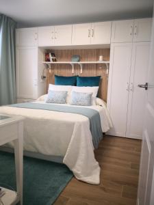 a bedroom with a large bed with white cabinets at Blu Oceano in Teguise