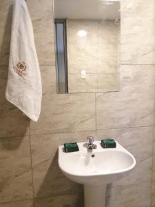 a bathroom with a white sink and a mirror at Hotel Brickell in Lima