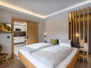 um quarto com uma cama grande e uma cozinha em Tirol Appartements Schwaiger em Niederndorf