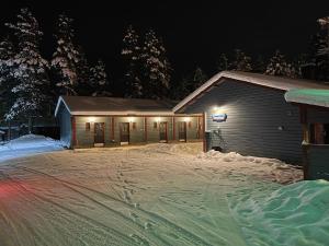 a building with a lot of snow in front of it at Luppoloma in Saariselka