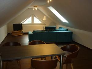 Pension Dachgeschosswohnung في Bastorf: غرفة معيشة مع أريكة وطاولة
