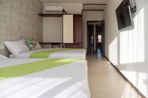 Postel nebo postele na pokoji v ubytování Hotel MAYARI Holbox