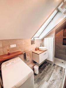 a bathroom with a white toilet and a sink at Chambres Privées dans une maison de charme in Saint-Brice-sous-Forêt