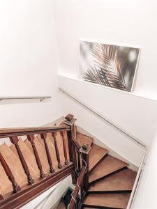 a spiral staircase in a house with a picture on the wall at Chambres Privées dans une maison de charme in Saint-Brice-sous-Forêt