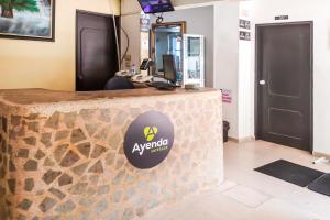 a counter with a sign on it in a room at Ayenda 1622 Charmin in Santa Marta